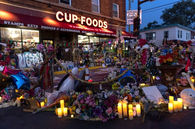 Candles flowers and signs were placed outside the Cup Foods store near the site where George Floyd was killed as a makeshift memorial in Minneapolis, Minnesota, on May 25, 2021, a year after his death.