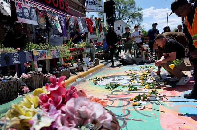 Jazz Hampton lays a rose as he and other community, family and friends pay their respects at the memorial site where George Floyd was murdered by former police officer Derek Chauvin ahead of the fifth anniversary of Floyd’s death in Minneapolis, Minnesota, U.S., May 23, 2025. REUTERS/Leah Millis