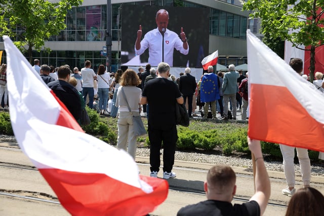 Polish Prime Minister Donald Tusk is shown on screen as he speaks on the day of the "Patriotic March" organised by the ruling party, ahead of the second round of presidential elections, in Warsaw, Poland, May 25, 2025. REUTERS/Kacper Pempel