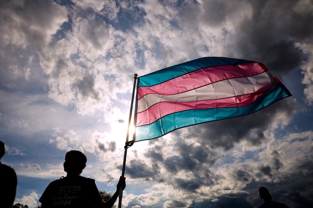 A transgender rights activist holds a flag during the Trans Day Of Visibility rally on the National Mall on March 31, 2025 in Washington City.