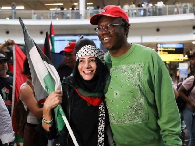 Advocate Tembeka Ngcukaitobi (R), a member of the South African legal team, is greeted by a supporter, after landing back in the country after representing the country in a two-day hearing against Isreal at the International Court of Justice (ICJ), at the OR Tambo International Airport in Ekurhuleni, South Africa, on January 14, 2024. South Africa on January 11, 2024 accused Israel of breaching the UN Genocide Convention, saying that even the deadly October 7 Hamas attack could not justify such alleged actions, as it opened a case at the top UN court. Pretoria has lodged an urgent appeal to the International Court of Justice (ICJ) to force Israel to "immediately suspend" its military operations in Gaza. (Photo by Alaister Russell / AFP) (Photo by ALAISTER RUSSELL/AFP via Getty Images)