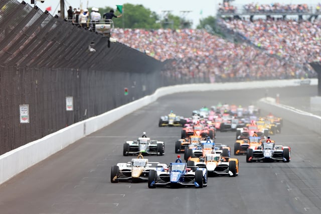 Alex Palou, driver of the #10 The American Legion Chip Ganassi Racing Honda, leads the pack of drivers at the start of The 107th Running of the Indianapolis 500 at Indianapolis Motor Speedway on May 28, 2023 in Indianapolis, Indiana.