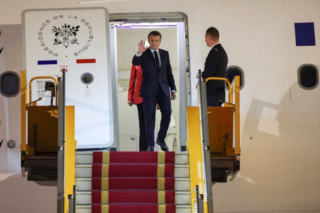 France's President Emmanuel Macron gestures upon his arrival at Noi Bai International Airport, marking the first trip to Vietnam by a French president in nearly a decade, in Hanoi, Vietnam, May 25, 2025. REUTERS/Chalinee Thirasupa REFILE - QUALITY REPEAT