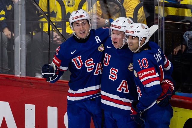 Jackson Lacombe of USA celebrates with teammates Zach Werenski and Matty Beniers after scoring 2-5 during the 2025 Ice Hockey World Championship match between Sweden and USA at Avicii Arena on May 24, 2025 in Stockholm, Sweden.
