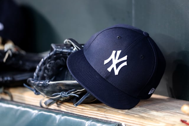 BALTIMORE, MARYLAND - APRIL 06: A New York Yankees hat and glove sit in the dugout before the start of the Yankees and Baltimore Orioles game at Oriole Park at Camden Yards on April 06, 2019 in Baltimore, Maryland.