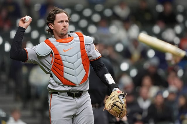Baltimore Orioles&#39; Adley Rutschman tosses the ball during the seventh inning of a baseball game against the Milwaukee Brewers, Tuesday, May 20, 2025, in Milwaukee. (AP Photo/Aaron Gash)