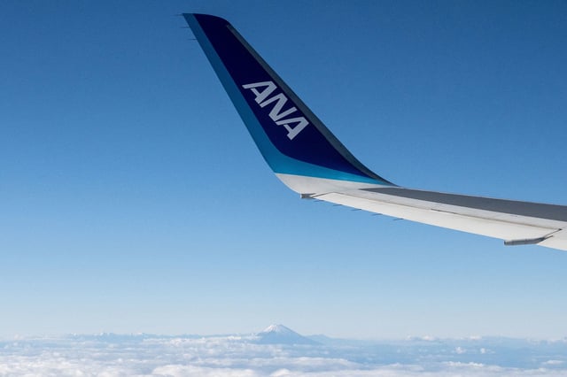 The wing of an an All Nippon Airways (ANA) aircraft is seen during a flight above Japan's Shizuoka prefecture on December 9, 2024.