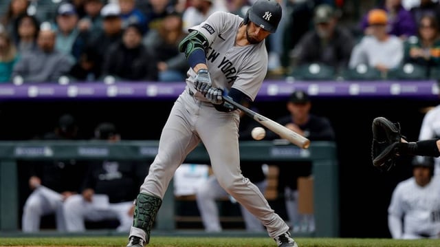 May 25, 2025; Denver, Colorado, USA; New York Yankees catcher J.C. Escarra (25) hits an RBI double in the second inning against the Colorado Rockies at Coors Field. Mandatory Credit: Isaiah J. Downing-Imagn Images