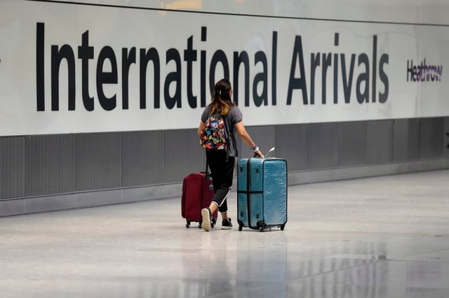 A passenger arrives after disembarking from a flight at Heathrow Airport in London. Photo: AP