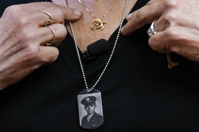 Diane Christie wears a necklace with a photograph of her uncle, World War II U.S. Army Air Forces 2nd Lt. Thomas Kelly, inside Santos Robinson Mortuary, Friday, May 23, 2025, in San Leandro, Calif. whose remains had been missing since being killed when the World War II bomber nicknamed Heaven Can Wait was hit by anti-aircraft fire and crashed into the water off the coast of New Guinea on March 11, 1944. (AP Photo/Godofredo A. Vásquez)