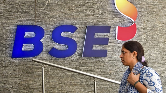 A woman walks into the Bombay Stock Exchange (BSE) building, in Mumbai.