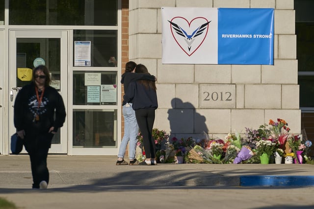 Young people embrace near a memorial at Walkerton District Community School in Walkerton, Ont. on Sunday, May 25, 2025. On Friday, four students and a teacher from the school were killed in a car accident on the way back from a softball tournament in Dorchester, Ontario.
THE CANADIAN PRESS/Geoff Robins