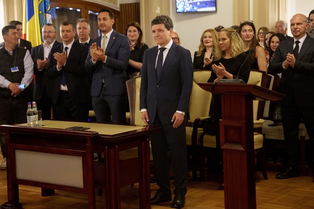 Romanian President elect Nicusor Dan, front center, stands at the Constitutional Court during the ceremony for validation of his presidential mandate, after winning the country's presidential election redo in Bucharest, Romania, Thursday, May 22, 2025. (AP Photo/Vadim Ghirda)