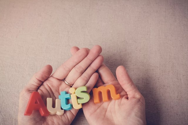Autism colorful word on hands