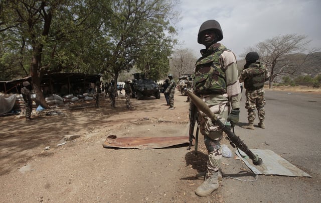 FILE - Nigerian soldiers man a checkpoint in Gwoza, northeast, Nigeria, April 8, 2015. (AP Photo/Lekan Oyekanmi, File)