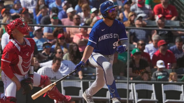 Mar 17, 2023; Tempe, Arizona, USA; Kansas City Royals right fielder John Rave hits a sacrifice RBI flyout against the Los Angeles Angels in the fourth inning at Tempe Diablo Stadium. Mandatory Credit: Rick Scuteri-USA TODAY Sports