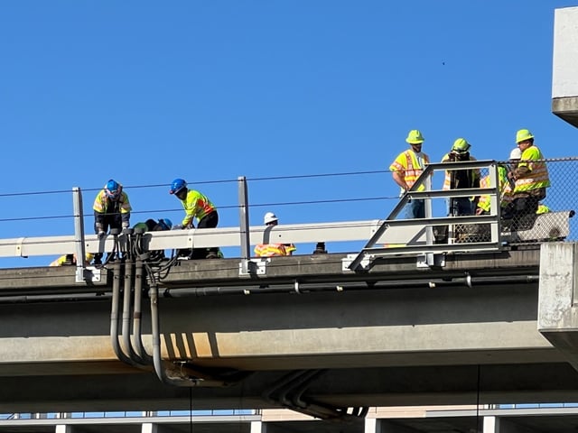 Workers investigate the scene of a fire near the San Leandro BART station Tuesday morning, May 20, 2025, in San Leandro, Ca. BART service between the Lake Merritt, Berryessa and Dublin stations was stopped because of the fire, officials said. (Laura Oda/Bay Area News Group)