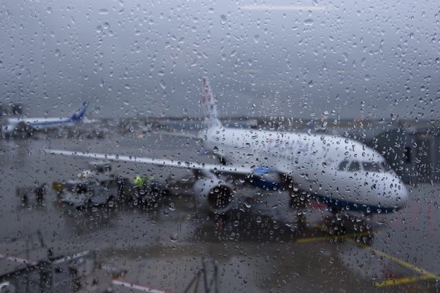 A stock image shows a plane in the rain.