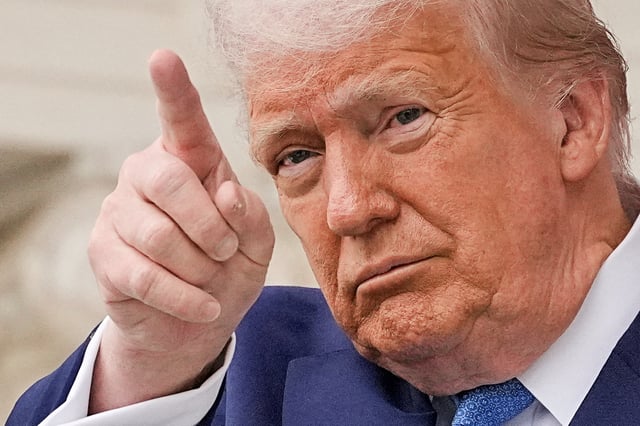 U.S. President Donald Trump gestures at the annual National Memorial Day Observance in the Memorial Amphitheater, at Arlington National Cemetery in Arlington, Virginia, U.S., May 26, 2025. REUTERS/Ken Cedeno/File Photo