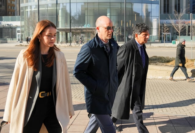 Jeffrey Wood, centre, arrives at the Ottawa courthouse alongside Lawrence Greenspon, right, and Hannah Drennan for a hearing in Ottawa, on Friday, March 14, 2025.