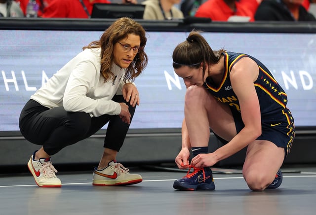 Head coach Stephanie White speaks with Caitlin Clark #22 of the Indiana Fever during the first quarter of a preseason game against the Atlanta Dream at Gateway Center Arena on May 10, 2025 in College Park, Georgia.