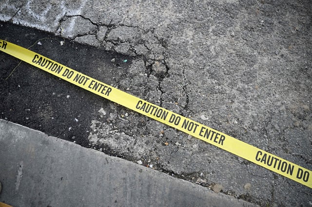 Police tape is seen on the ground at the scene of a mass shooting in Monterey Park, California, on January 22, 2023.