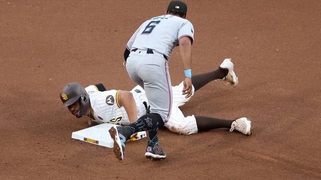 Otto Lopez (6) of the Miami Marlins is unable to place the tag in time as Xander Bogaerts (2) of the San Diego Padres steals second base during the fourth inning of a game at Petco Park on Monday, May 26, 2025, in San Diego. (Sean M. Haffey/Getty Images/TNS)