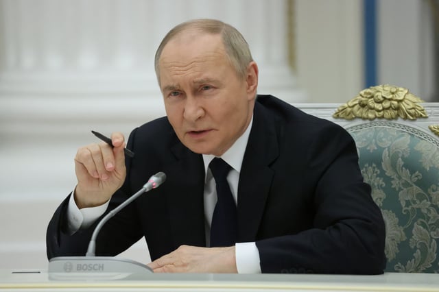 Russian President Vladimir Putin gestures during his meeting with local business leaders at the Saint Yekeaterina&#39;s Hall of the Kremlin, May 26, 2025 in Moscow, Russia.