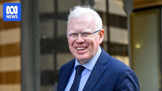 A man smiles at the camera.
