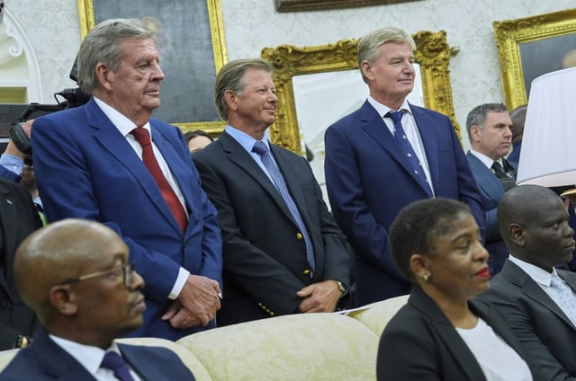 South African businessman Johann Rupert, left, and South African golfers Retief Goosen, center, and Ernie Els, right, look on as President Donald Trump meets South African President Cyril Ramaphosa in the Oval Office of the White House.
