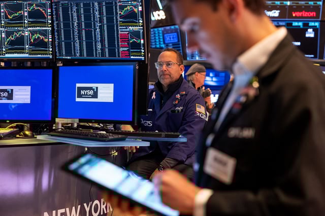 Traders work on the floor of the New York Stock Exchange.