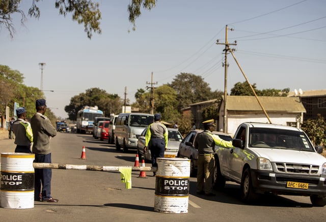 FILE - Police man at a roadblock in Bulawayo, Zimbabwe, Monday, Aug. 19, 2019. (AP Photo/Mpofu, File)
