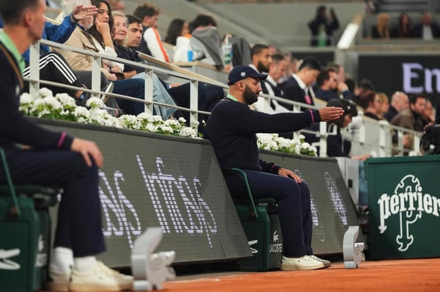 A line judge makes a call as Anastasia Pavliuchenkova plays Zheng Qinwen during their first-round match of the French Open on May 25. (Lindsey Wasson/Associated Press)