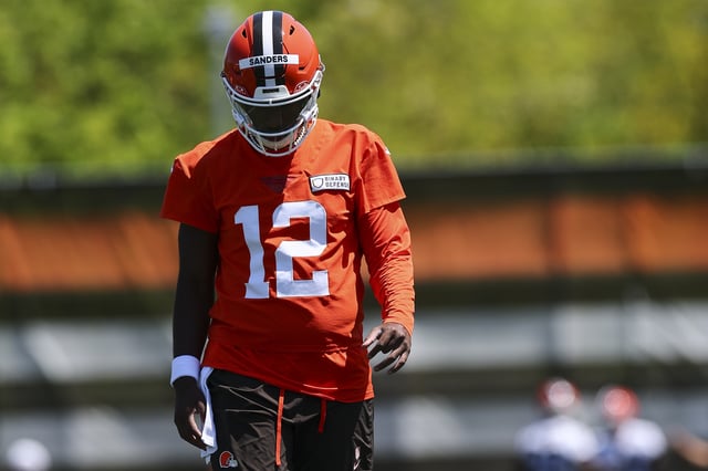 Shedeur Sanders #12 of the Cleveland Browns walks on the field during rookie minicamp at CrossCountry Mortgage Campus on May 10, 2025 in Berea, Ohio.