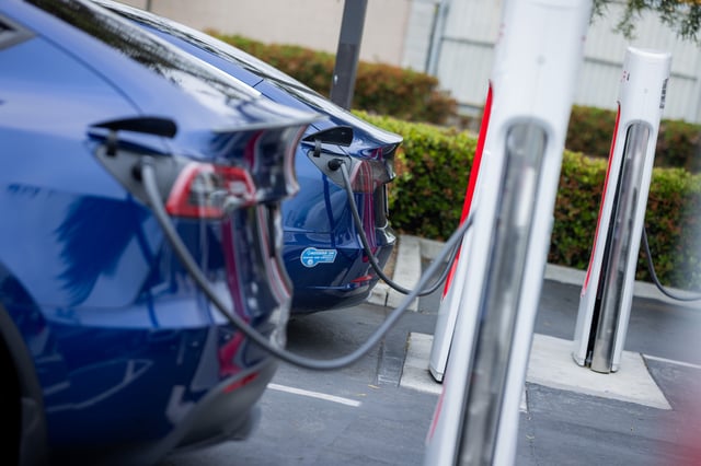 Tesla cars are seen parked and charging at a Tesla Supercharger on May 2, 2025 in Hawthorne, California.
