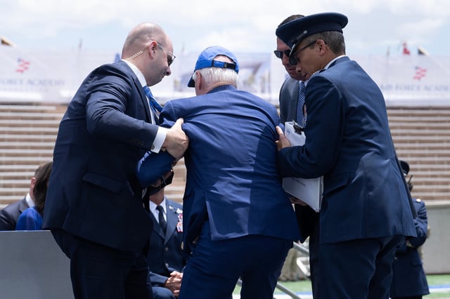 The then US President, Joe Biden, is helped to his feet after falling during the graduation ceremony at the United States Air Force Academy in Colorado on June 1, 2023.