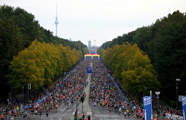 Runners at the Berlin Marathon in 2022, with the city's Brandenburg Gate and TV Tower in the background.