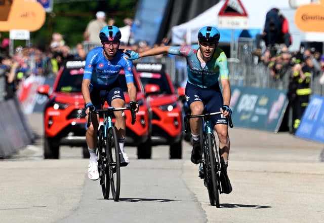 Cycling - Giro d'Italia - Stage 16 - Piazzola sul Brenta to San Valentino - Italy - May 27, 2025 XDS Astana Team's Christian Scaroni crosses the finish line to win stage 16, alongside second placed XDS Astana Team's Lorenzo Fortunato REUTERS/Jennifer Lorenzini