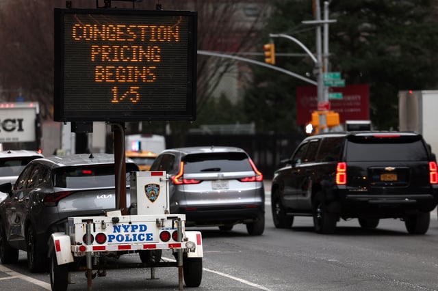 Vehicles pass a sign on 9th Avenue announcing New York City's congestion pricing program in effect charging drivers for entering the central business district in Manhattan below 60th street in New York City, U.S., January 6, 2025. REUTERS/Mike Segar/File Photo