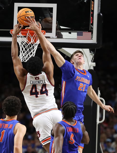 Florida forward Alex Condon (21) blocks a slam dunk attempt by Auburn center Dylan Cardwell (44) during the NCAA Final Four college basketball game of Florida versus Auburn at the Alamodome in San Antonio Texas on Saturday, April 5, 2025. Florida won the game 79-73 to advance to the championship game. (Stephen M. Dowell/Orlando Sentinel)