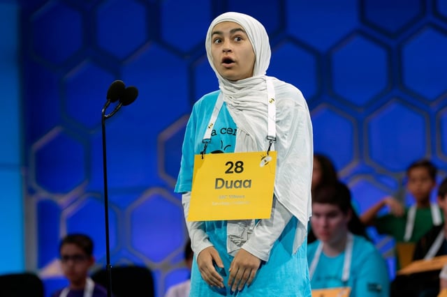 Duaa Siyah Ouznali, 13, of San Diego, reacts after correctly spelling her word as she competes during the first preliminary round of the Scripps National Spelling Bee at the Gaylord National Resort &amp; Convention Center, Tuesday, May 27, 2025, in Oxon Hill, Md. (AP Photo/Jose Luis Magana)