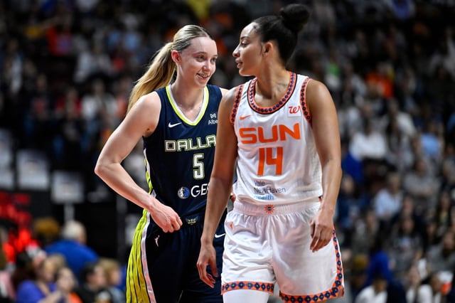 Dallas Wings guard Paige Bueckers (5) and Connecticut Sun guard Bria Hartley (14) walk onto the court together during the first half of WNBA game at Mohegan Sun in Uncasville, Conn., Tuesday, May 27, 2025. (Jessica Hill/Special to the Courant)