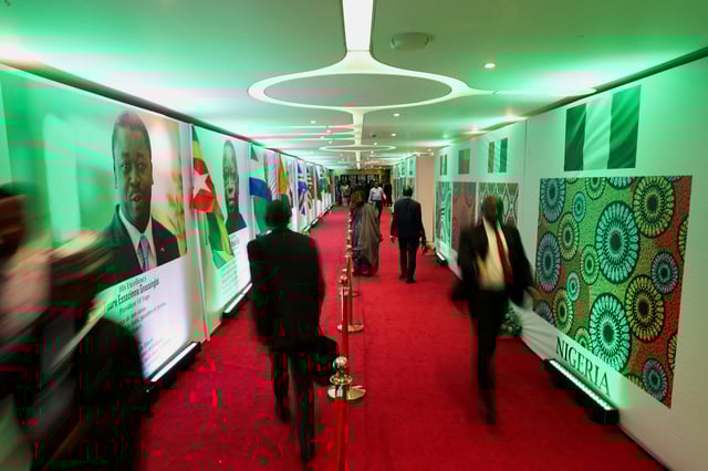 People walk into the Eko Conventional Hall where leaders from the Economic Community of West African States (ECOWAS) will gather to celebrate the golden jubilee of the regional bloc in Nigeria's commercial capital, Lagos, Nigeria, May 28, 2025. Picture taken using slow shutter speed. REUTERS/Sodiq Adelakun