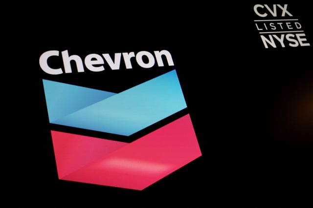 The logo and trading information for Chevron is displayed on a screen on the floor of the New York Stock Exchange (NYSE) in New York City, U.S., June 27, 2022.  REUTERS/Brendan McDermid/File Photo