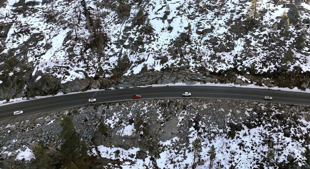 A drone view of cars driving along Highway 50 near patchy snow on the ground in Twin Bridges, California, U.S. January 2, 2025.  REUTERS/Fred Greaves/File Photo