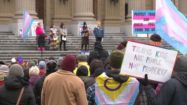 Opponents of the Alberta UCP government's legislation affecting Transgender people hold a rally outside the Alberta legislature in March 2025.