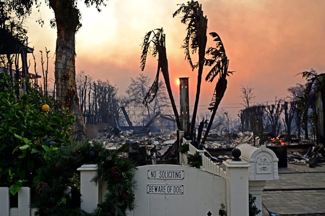A front gate and mailbox stand intact in front of the ruins of a home after the passage of the Palisades Fire in Pacific Palisades, California, on Jan. 8, 2025.