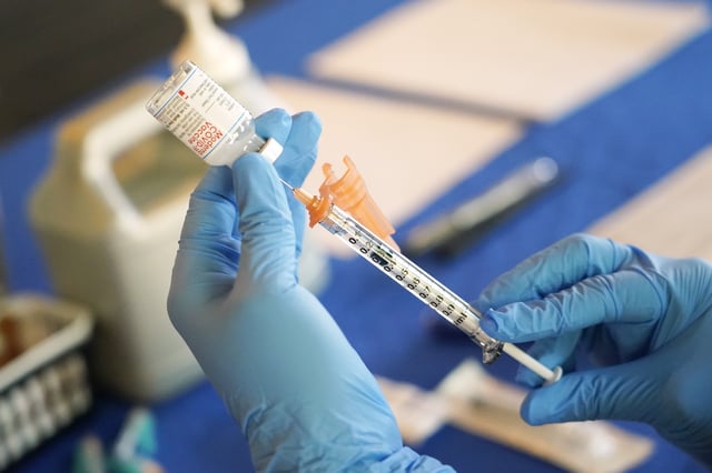 FILE – A nurse prepares a syringe of a COVID-19 vaccine at an inoculation station in Jackson, Miss., July 19, 2022. U.S. health officials are proposing a simplified approach to COVID-19 vaccinations, which would allow most adults and children to get a once-a-year shot to protect against the mutating virus. The new system unveiled Monday, Jan. 23, 2023 would make COVID-19 inoculations more like the annual flu shot. Americans would no longer have to keep track of how many shots they’ve received or how many months it’s been since their last booster. 