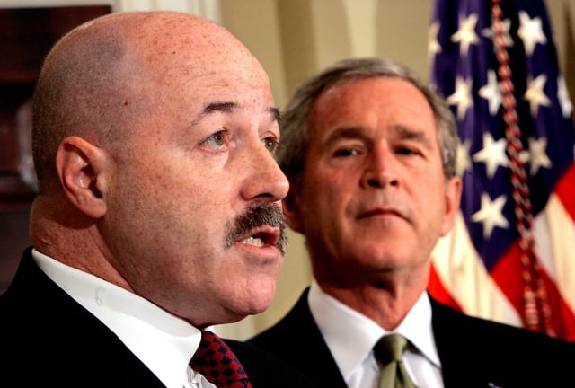 U.S. President George W. Bush listens to remarks after he announced that former New York City police commissioner Bernard Kerik (L), who helped the city respond to the September 11, 2001, attacks and trained Iraqi police, will become the new homeland security secretary, December 3, 2004. REUTERS/Kevin Lamarque/File Photo
