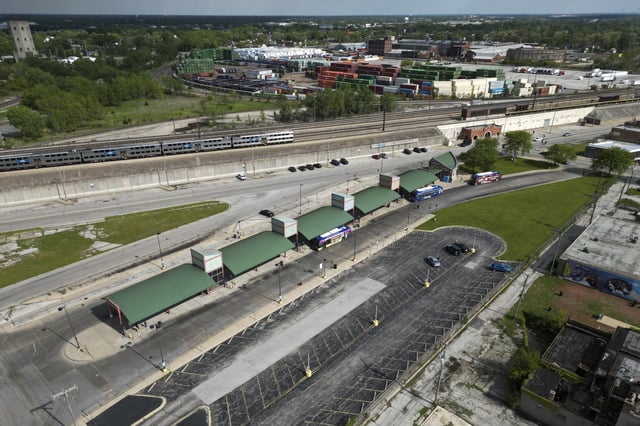 A Metra train, top, is seen in the tracks across from the Pace Harvey Transportation Center, Thursday, May 29, 2025, in Harvey, Ill. (AP Photo/Erin Hooley)